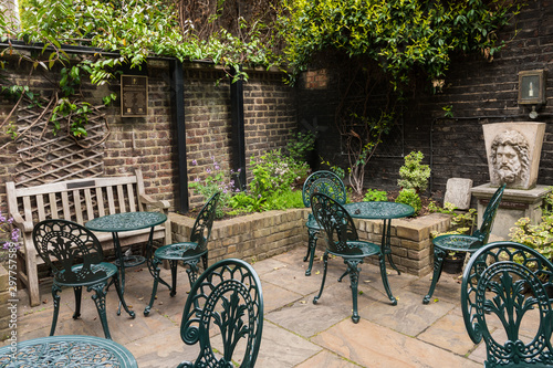 Charles Dickens Museum, 48 Doughty Street in Holborn, London Borough of Camden (England, UK). Beautiful garden cafe. The author lived here in 1837. Green chairs, tables and nature.