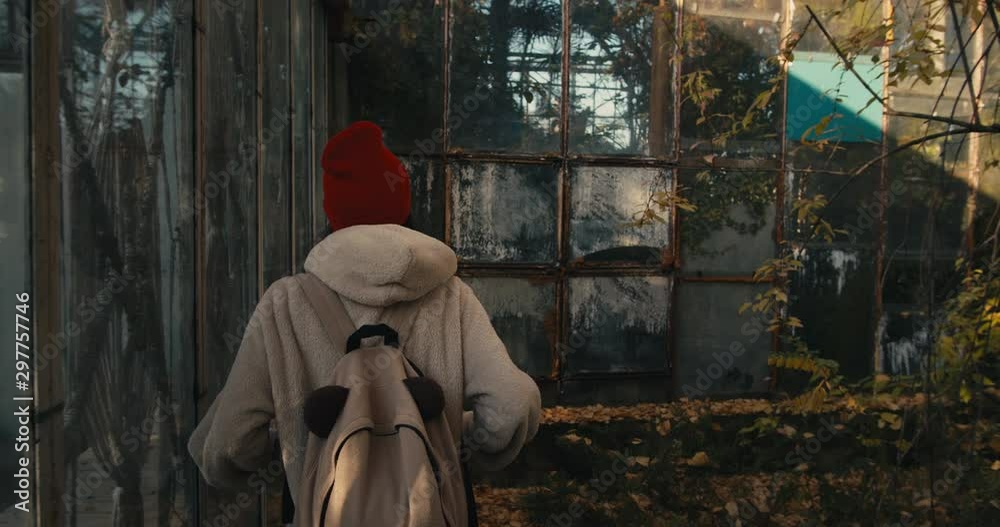 Young attractive female tourist with backpack exploring abandoned soviet buildings. Young attractive female tourist with backpack exploring abandoned soviet buildings.