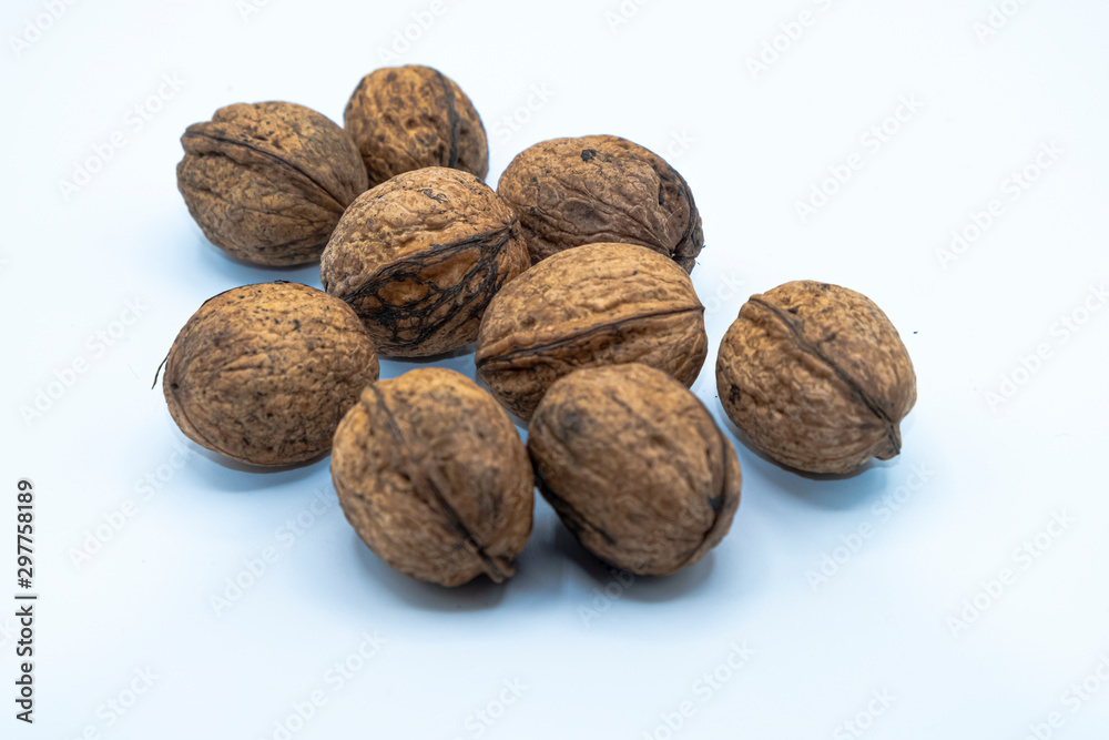 Freshly harvested organic wallnuts, white background. Freshly harvested organic wallnuts, white background.