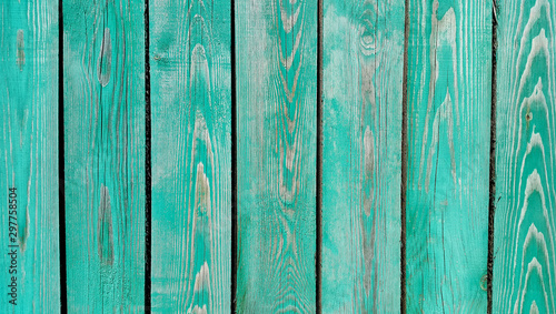 Texture of weathered wooden green painted fence
