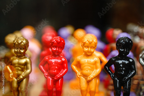 Multi-colored figures of pissing boy in a shop window in Brussels. Belgian souvenirs concept.