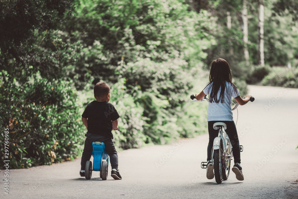 couple riding bicycle in park