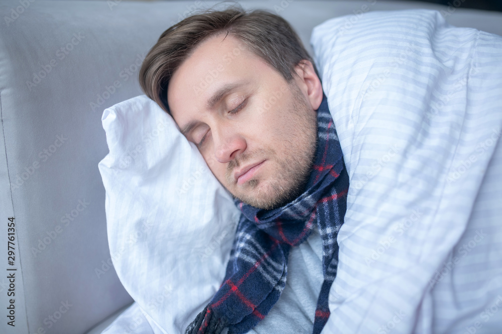 Bearded man sleeping while having high body temperature - obrazy, fototapety, plakaty 