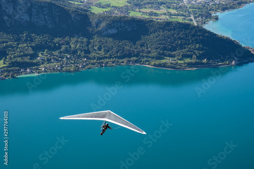 Hang glider flying over a lake, Annecy, France photo