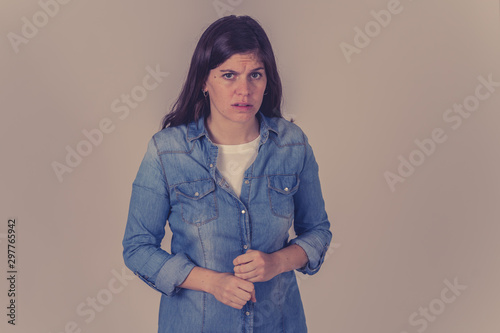 Portrait of sad and depressed woman. Isolated on neutral background. Human expressions and emotions