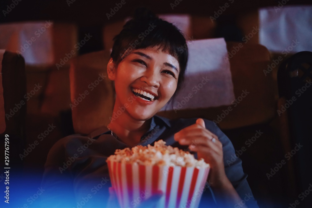 woman with popcorn and watching movie 