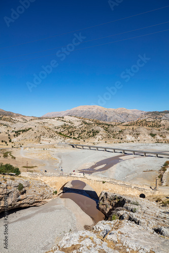 The historical Severan Bridge Adiyaman, which is located on the Cendere River and is considered one of the oldest used bridges in the world. It is located in an ancient settlement area Eskikale. photo