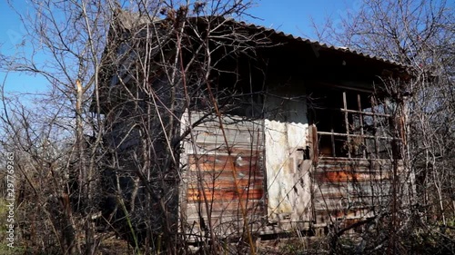 An old abandoned house Devastation Broken Windows Decline. An old home in the village has falling apart succumbing to the elements of heat and wind.