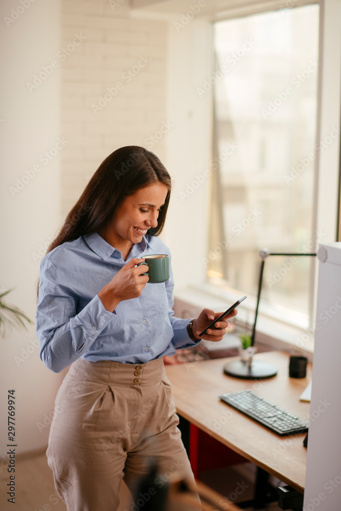 Portrait of young woman with cup of coffee and smartphone Portrait of young woman with cup of coffee and smartphone