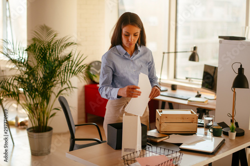 Young businesswoman in office organizing documents