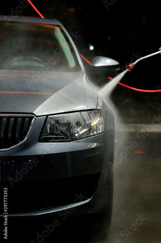 Car close-up. Car wash. Manual car wash with pressurized water in car wash outside. 