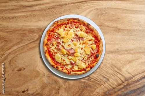Delicious Hawai pizza on splendid wooden background