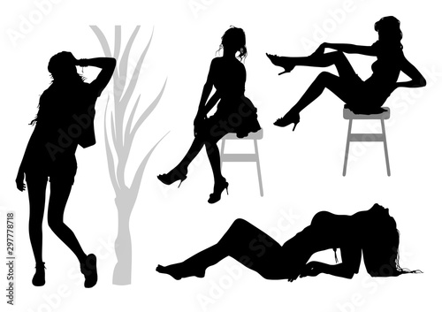 Silhouettes of a group of slender tall girls with long legs and developing hair who pose for the photographer in  various poses: sitting on a chair, lying and standing by a tree
