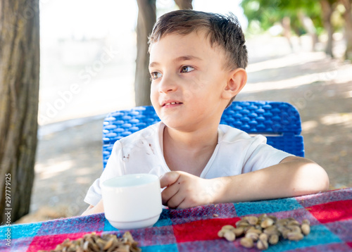 Happy arabic enjoyong eating pistachio in the park outdoor photo