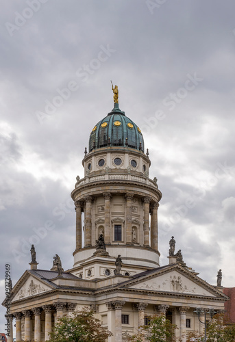 Vertical image of the Franzosischer Dom in the Gendarmenmarkt square, Berlin, Germany, on a typical winter day with cloudy skies