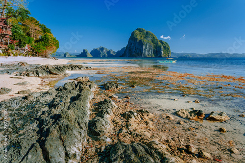 Rocky exotic coastline in front of Pinagbuyutan island. Dreamlike landscape scenery at El Nido, Palawan, Philippines