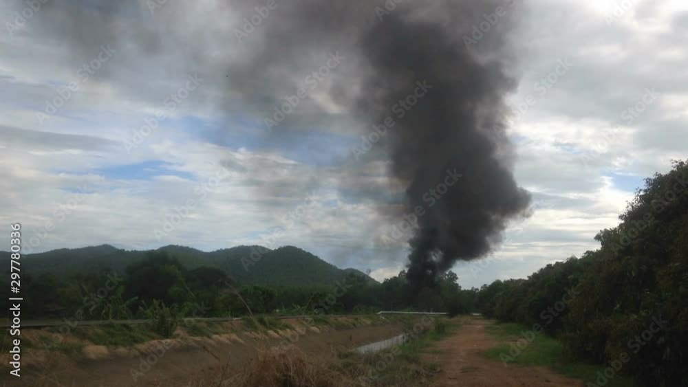 Dark smoke group beside the road with irrigation canal in countryside, air pollution, global warming. Full hd footage. Dark smoke group beside the road with irrigation canal in countryside, air pollution, global warming. Full hd footage.