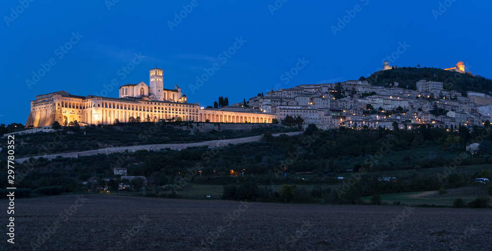 Panoramic landscape. Assisi Basilica of St. Francis at sunset. Night amazing view