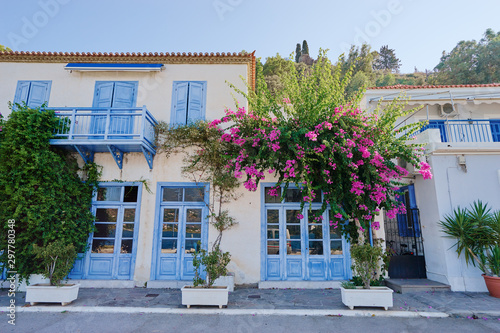 Traditional white houses Aegean architecture. Beautiful cityscape with red tiled roofs of  Poros town, Greece. © luengo_ua