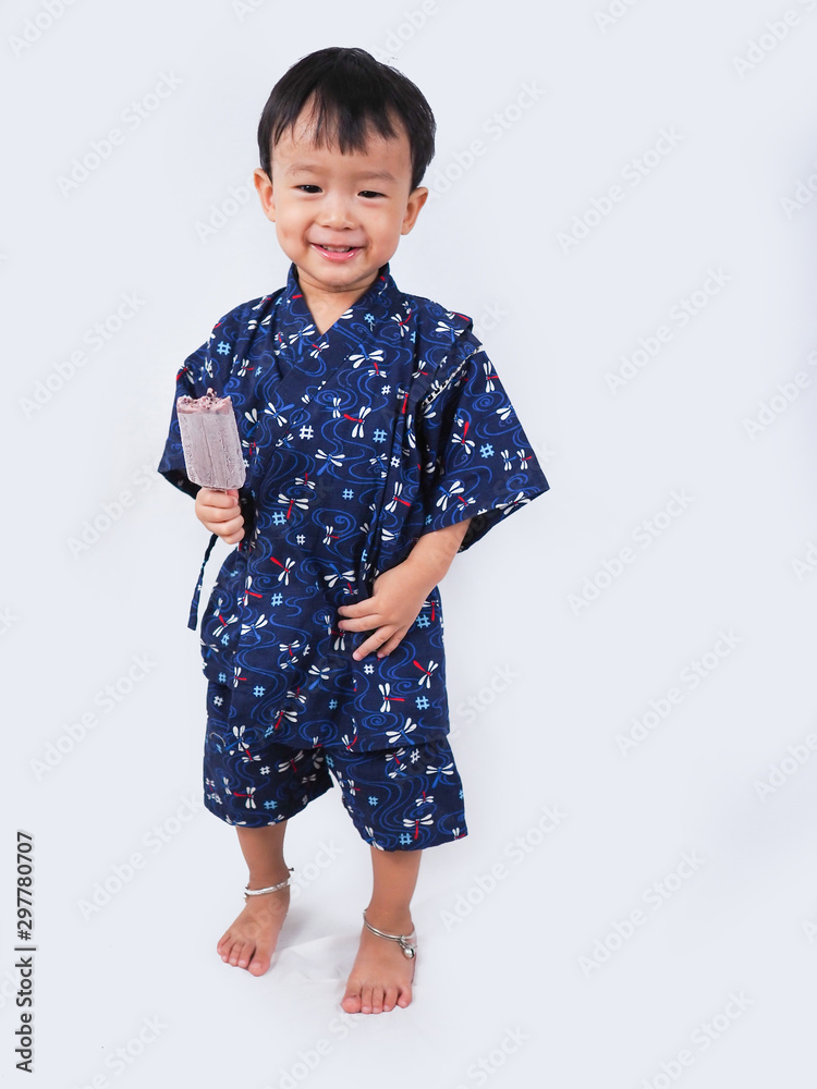 asian little boy Wearing yukata eating ice cream on white backgound asian little boy Wearing yukata eating ice cream on white backgound