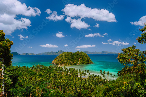 Tropical scenery of bacuit archipelago with palm trees, island and blue lagoon. El Nido, Palawan, Philippines