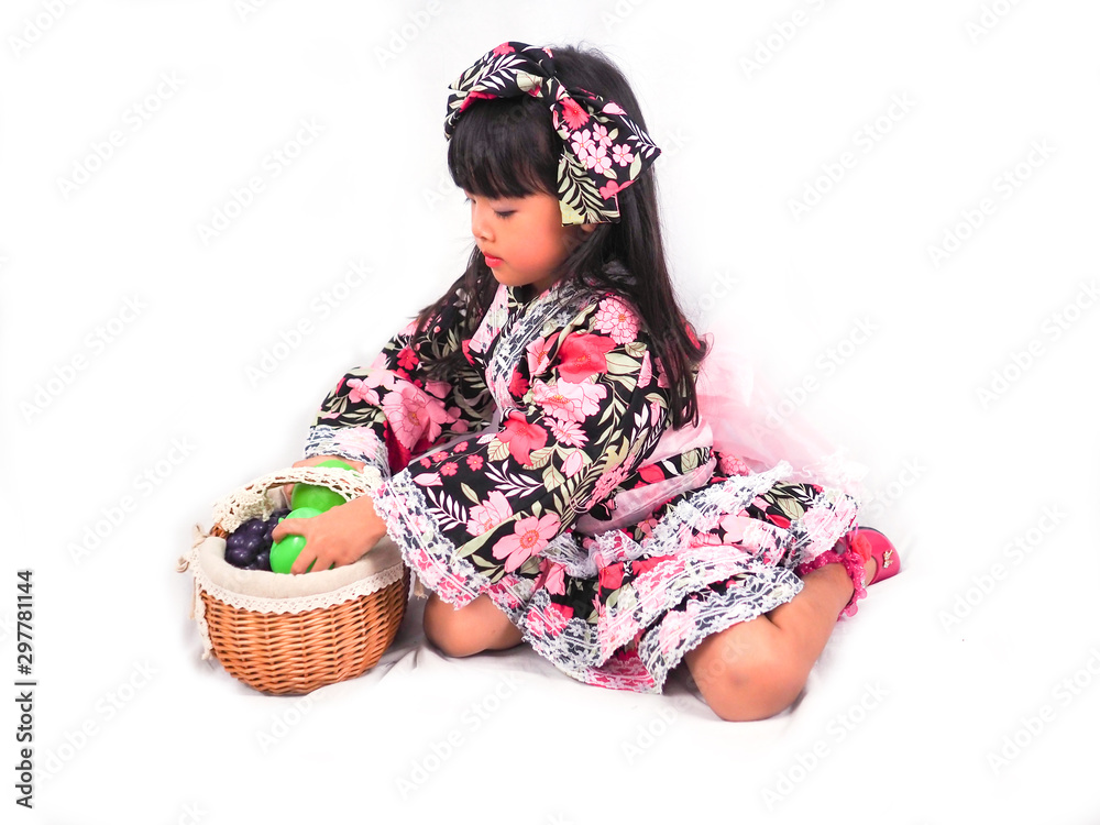 asian little girl  Wearing yukata with fruit basket on white backgound