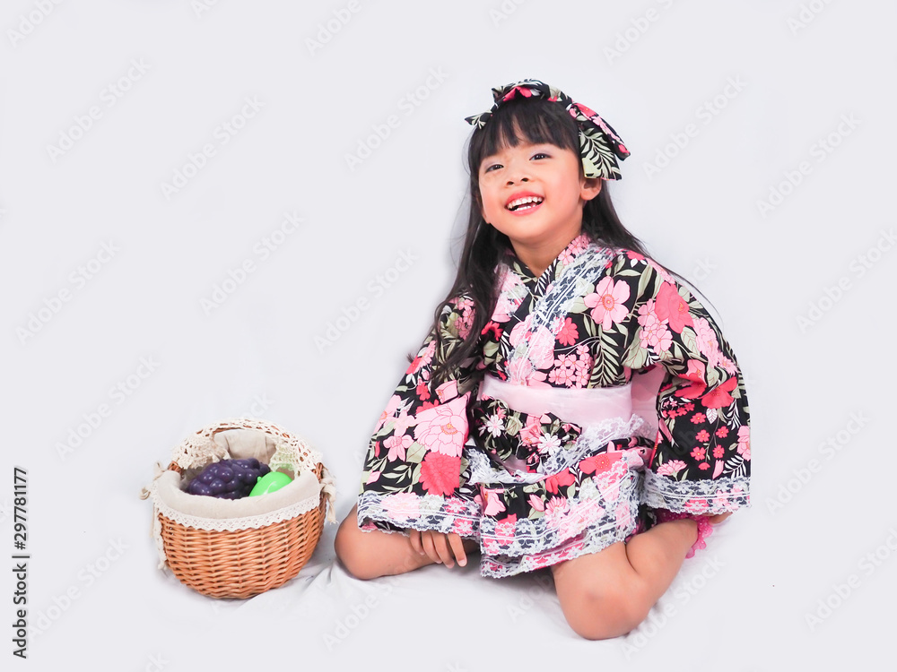 asian little girl Wearing yukata with fruit basket on white backgound asian little girl Wearing yukata with fruit basket on white backgound