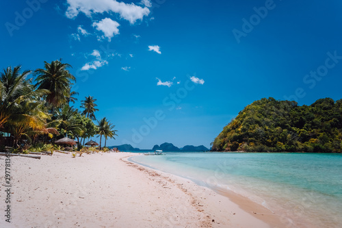 El Nido, Palawan, Philippines. Shallow lagoon, sandy beach with palm trees. Travel and vacation concept
