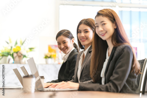 group of smart asian operator female formal uniform working with happiness and concentration modern office background