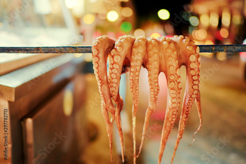 Fototapeta Naklejka Na Ścianę i Meble -  Octopus tentacles dried in a Greek tavern on the street in Greece.