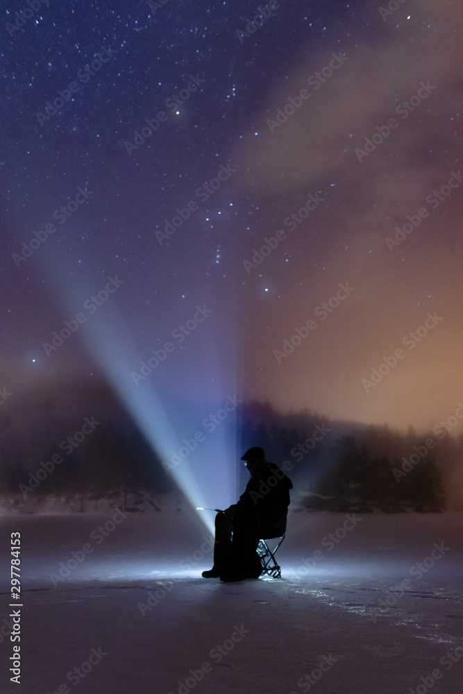 Ice fishing under the stars in Norway. Constellation is Orion. Ice fishing under the stars in Norway. Constellation is Orion.