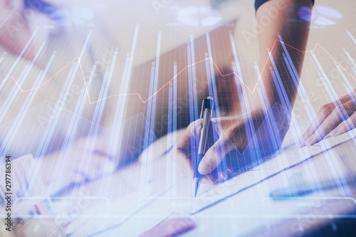 Wallpaper Mural A woman hands writing information about stock market in notepad. Forex chart holograms in front. Concept of research. Multi exposure Torontodigital.ca