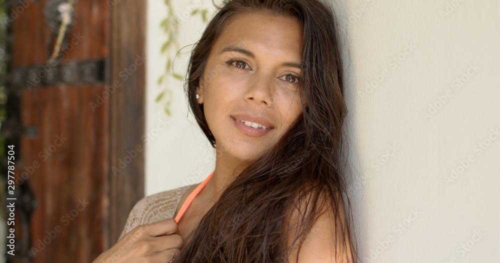 Sensual brunette leaning against white wall on terrace Sensual brunette leaning against white wall on terrace