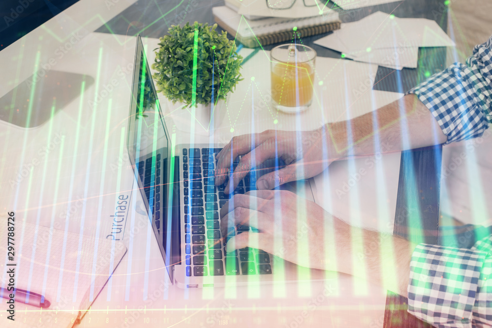 Obraz premium Multi exposure of graph with man typing on computer in office on background. Concept of hard work. Closeup.