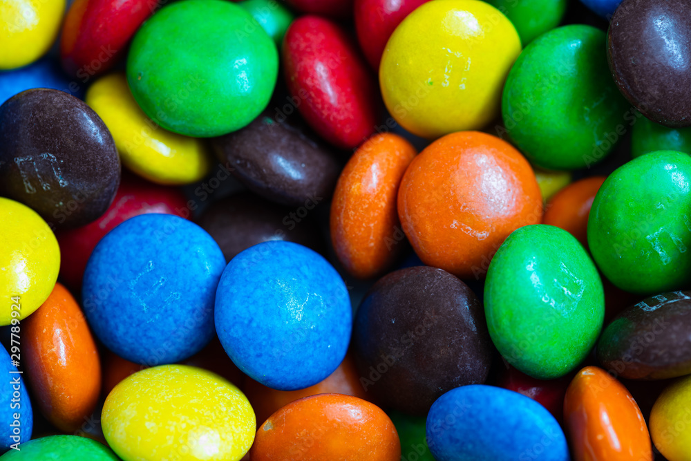 colorful chocolate buttons isolated on a black background colorful chocolate buttons isolated on a black background