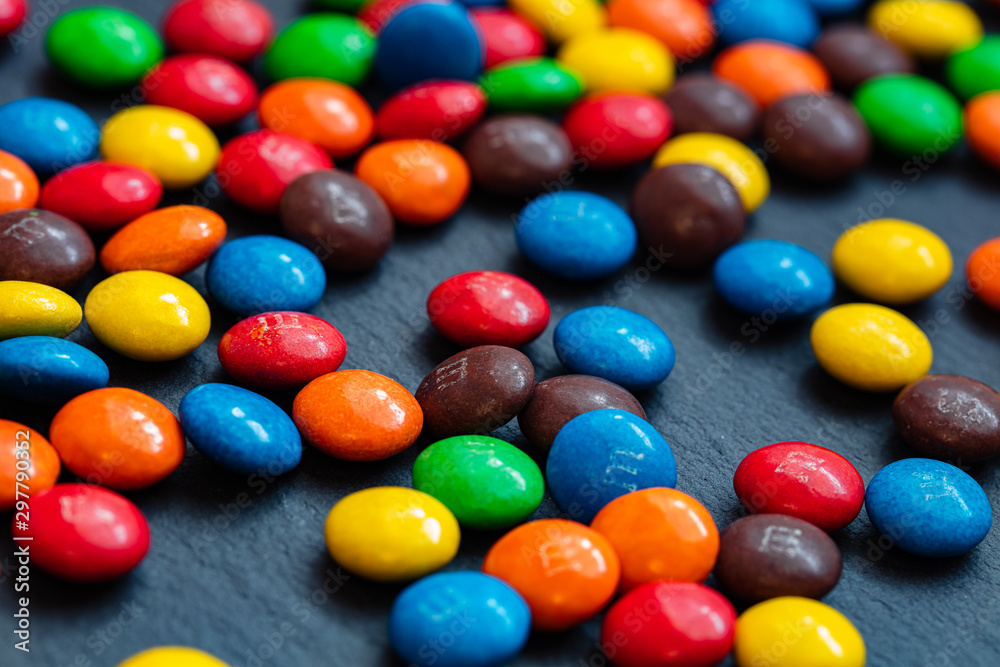 colorful chocolate buttons isolated on a black background colorful chocolate buttons isolated on a black background