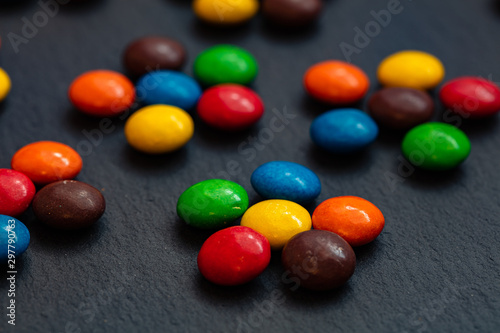 colorful chocolate buttons isolated on a black background