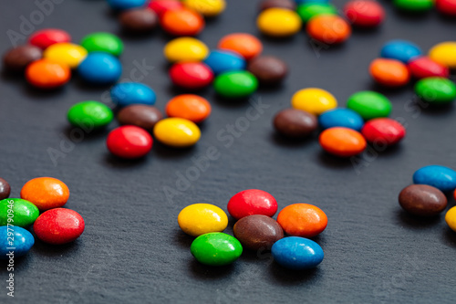 colorful chocolate buttons isolated on a black background