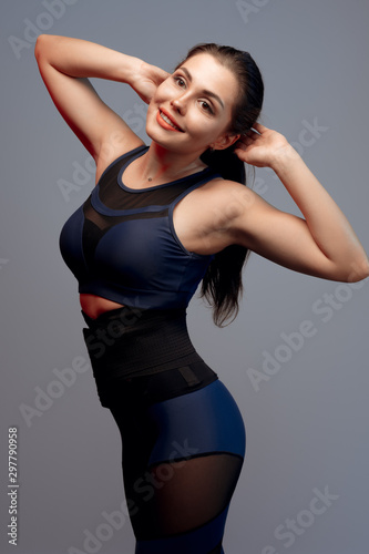 portrait of a young fitness woman in sportswear posing in studio