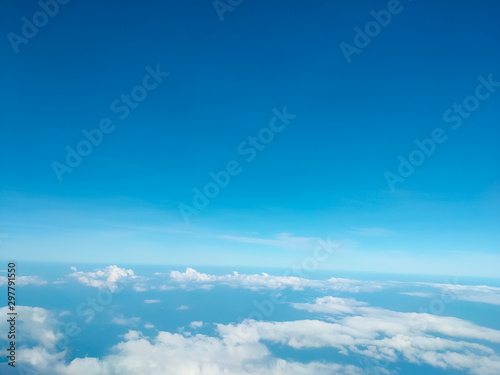 Sunrise above clouds from airplane window. Bright blue sky top horizontal view copyspace. Travelling concept View of the engine. © Elina