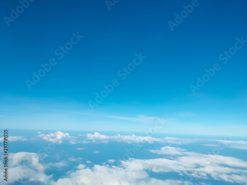 Sunrise above clouds from airplane window. Bright blue sky top horizontal view copyspace. Travelling concept View of the engine.