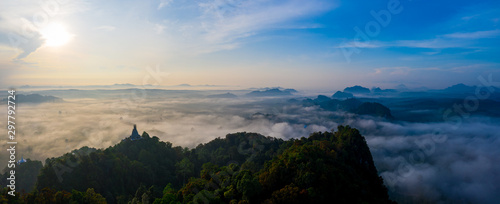 Fototapeta Naklejka Na Ścianę i Meble -  Aerial view of mountains with cloud cover mountain at sunrise and blue sky in Surat Thani Province, Thailand.