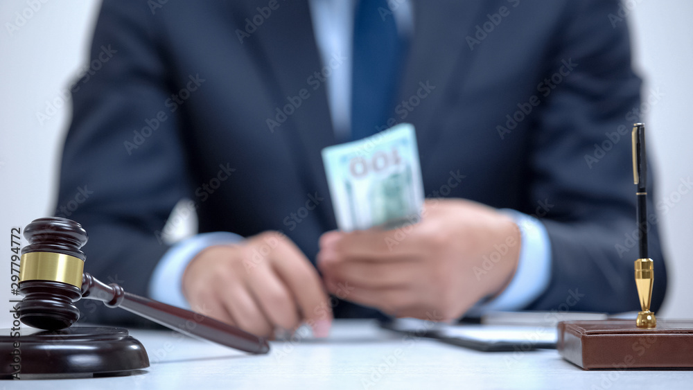 Corrupt lawyer holding bribe money in hands, falsified business agreement, crime Corrupt lawyer holding bribe money in hands, falsified business agreement, crime