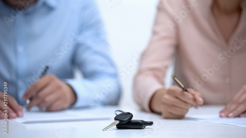 Εκτύπωση καμβά Car keys closeup, couple signing divorce documents about property division