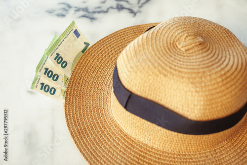 Sun hat with 100 hundredth euro banknotes. Vacation concept