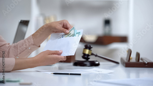 Divorced woman holding envelope with dollars, savings for single mom, allowance