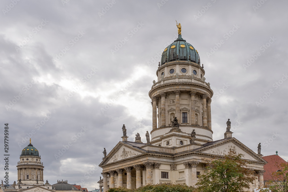 The twin churches of the Gendarmenmarkt square in Berlin, Germany, under a typically winter and cloudy sky