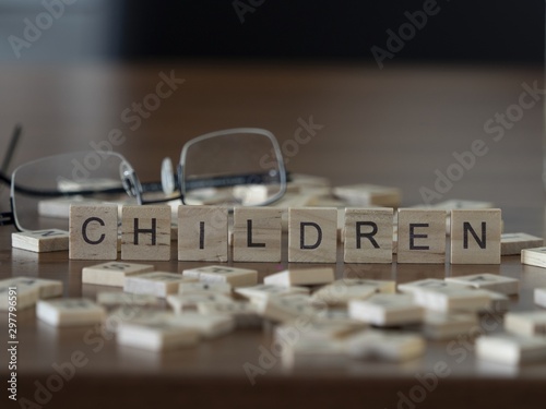 The concept of Children represented by wooden letter tiles photo