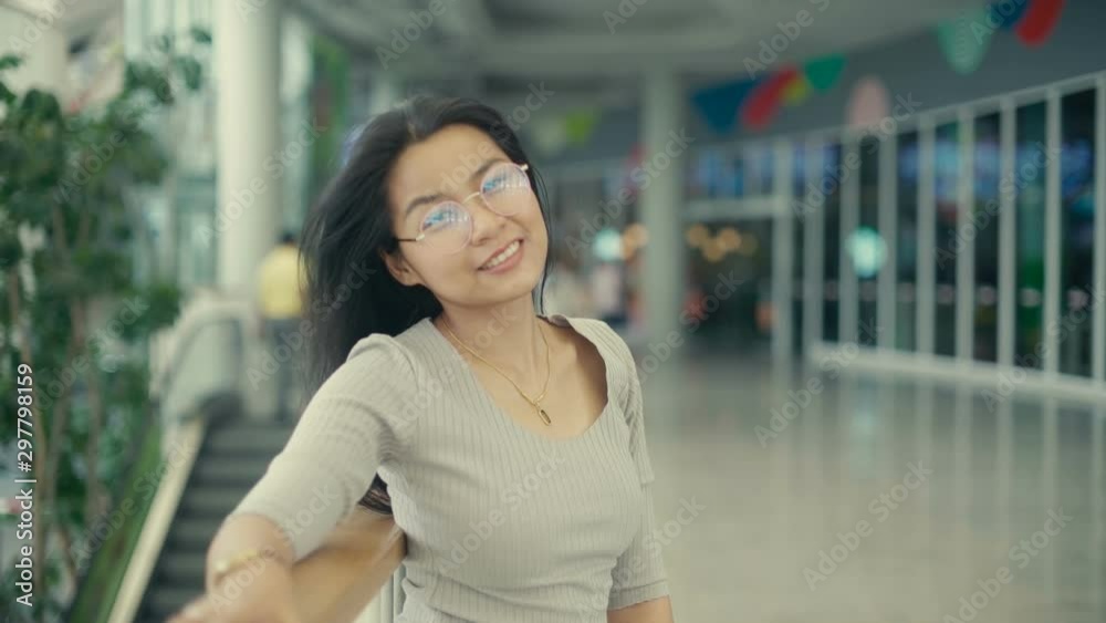 Portrait of Young Thai Woman in glasses standing in terrace of office building. Slow motion Portrait of Young Thai Woman in glasses standing in terrace of office building. Slow motion