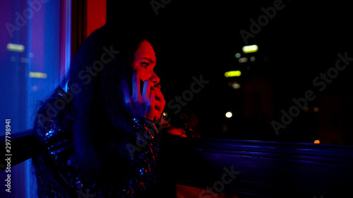 Canvas-taulu Frightened woman calling police, informing about disorder at night private party